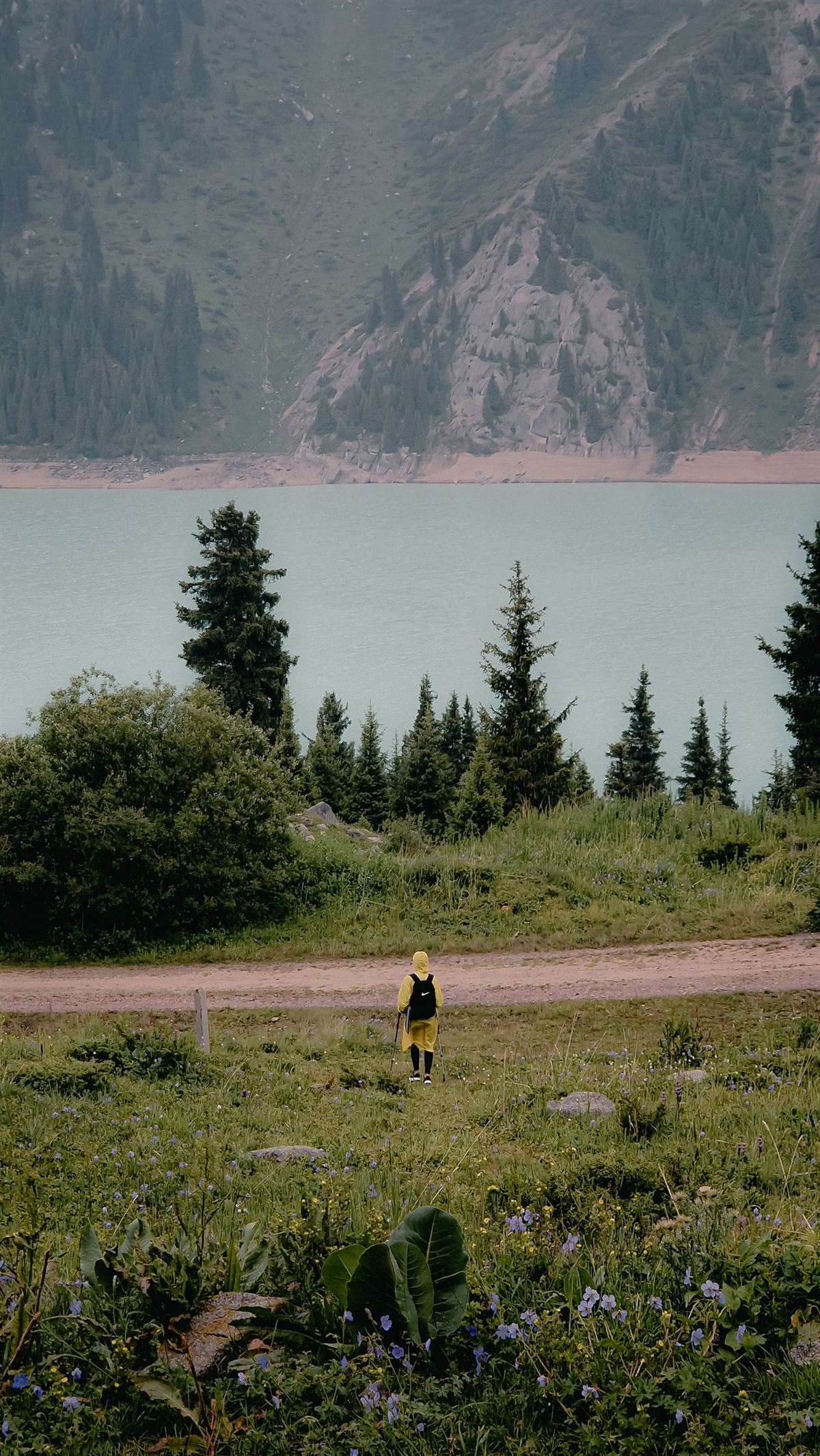 A hiker beside Big Almaty Lake in the Tian Shan, Kazakhstan
